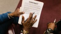 Legal contract being reviewed, illustrating the AFM Warner AI licensing dispute