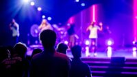 Audience watching musicians perform at a live concert