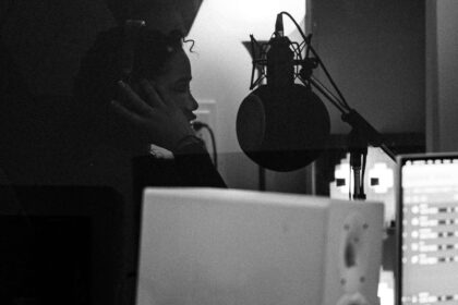 Female artist recording vocals in a professional music studio