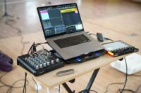 Computer and music production equipment representing Suno AI training and YouTube stream-ripping case