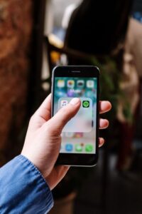 Smartphone displaying music streaming apps including Apple Music