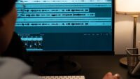 Sound engineer analyzing audio on a computer