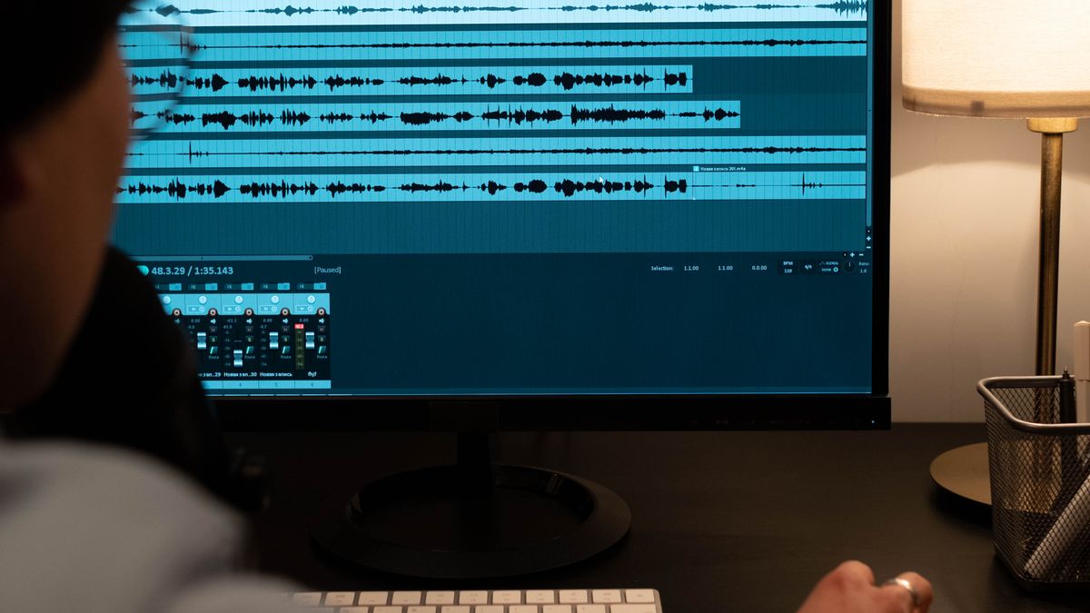 Sound engineer analyzing audio on a computer