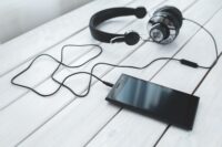 Smartphone displaying music streaming apps including Apple Music