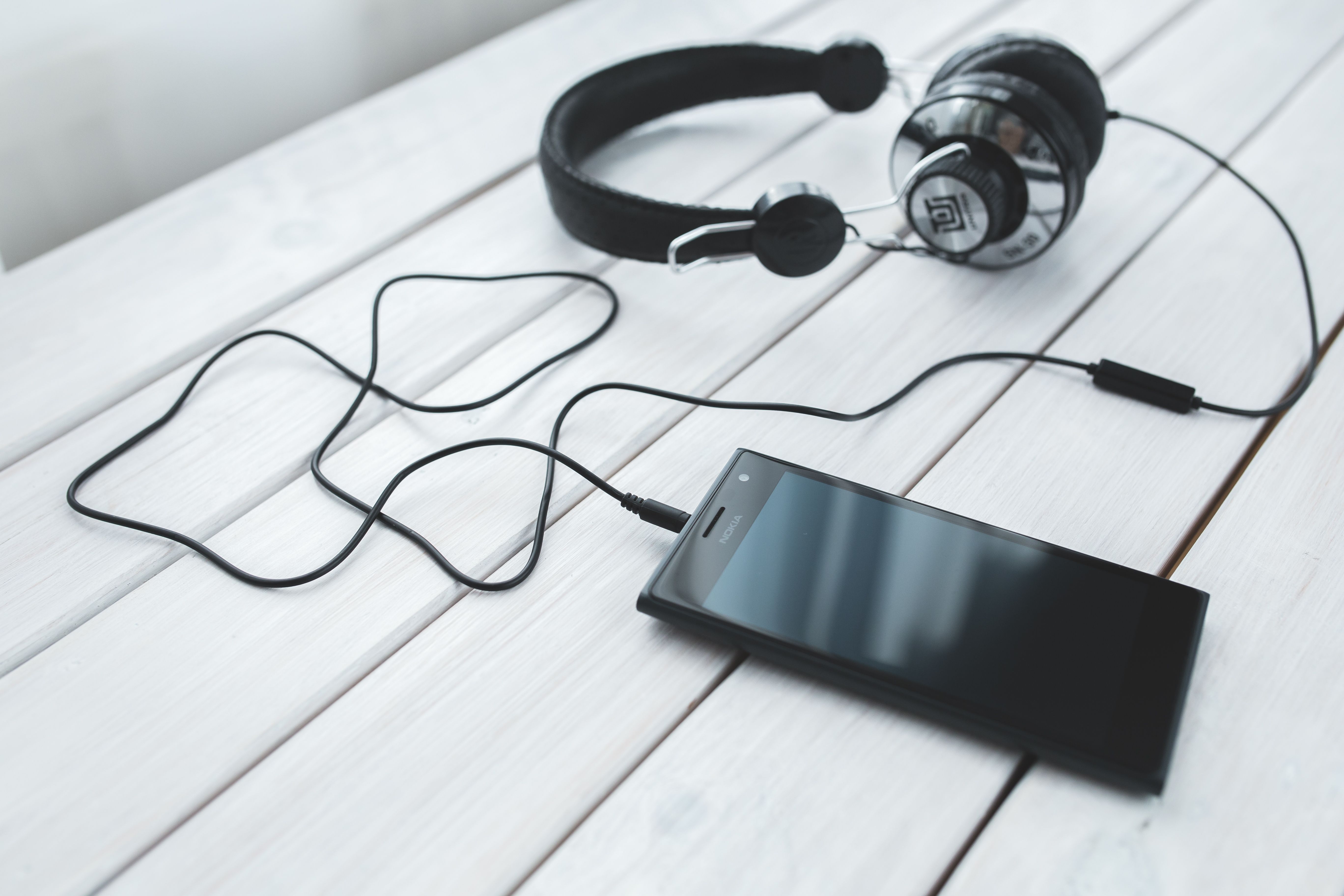 Smartphone displaying music streaming apps including Apple Music